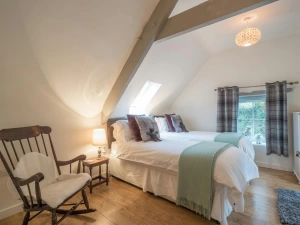 Twin  single beds, bedside table with lamp and rocking chair