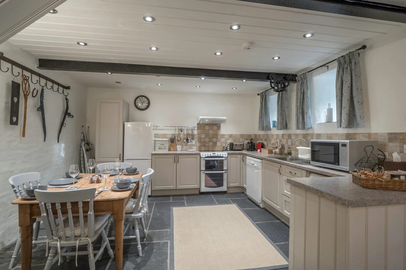 Kitchen/diner: table with four chairs, cooker, microwave, fridge/freezer, dishwasher, kettle and toaster
