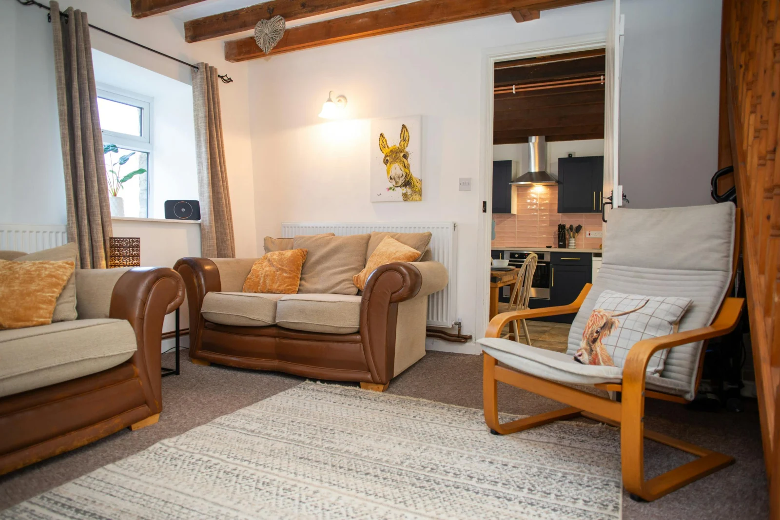 Door leading from the lounge to the kitchen/dining room; sofas and armchair
