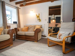 Door leading from the lounge to the kitchen/dining room; sofas and armchair