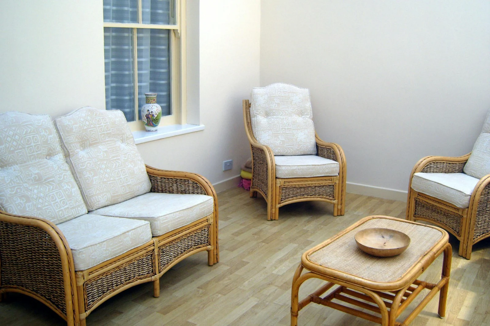 Comfortable conservatory - sit & relax on wicker sofa and chairs by the coffee table