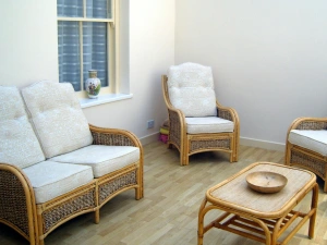 Comfortable conservatory - sit & relax on wicker sofa and chairs by the coffee table