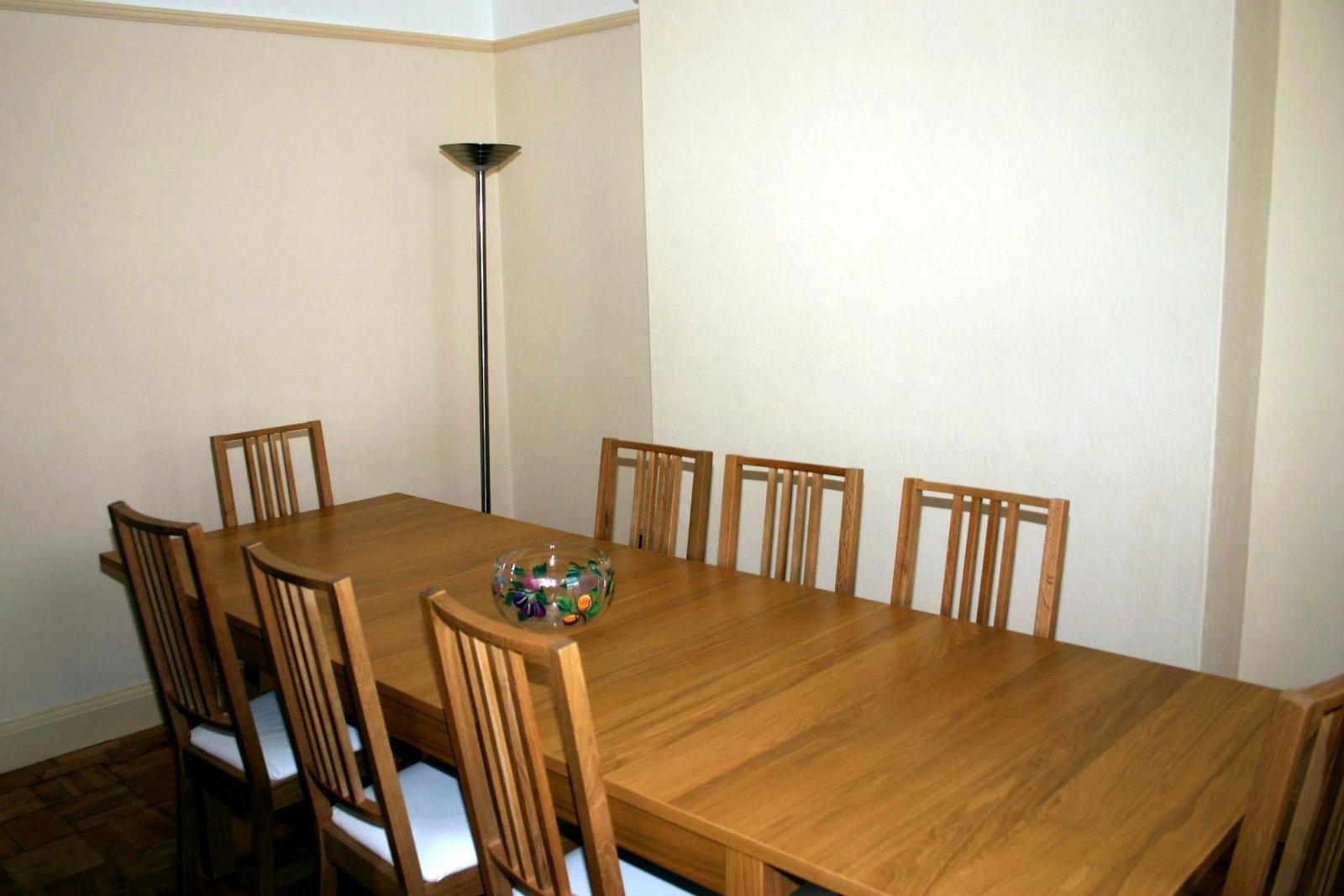 Separate dining room - table for eight with corner standard lamp