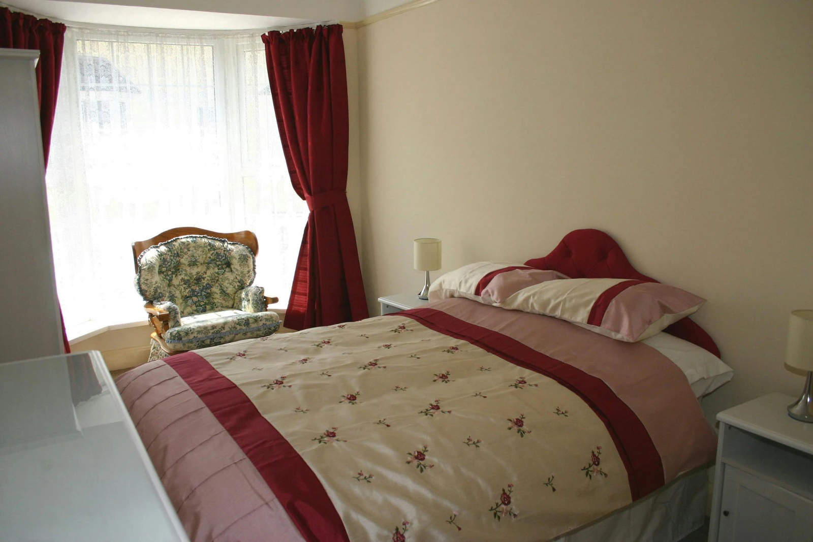 Double bed, chair and bedside cabinets with lamps