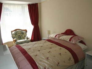 Double bed, chair and bedside cabinets with lamps