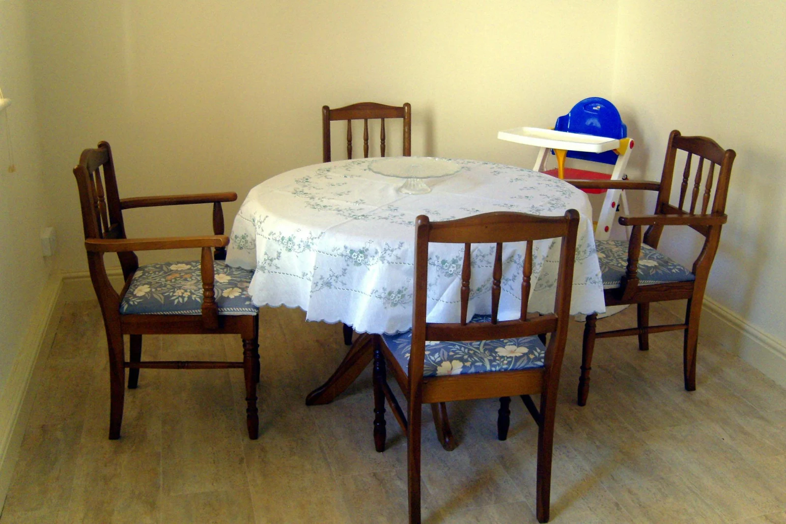Extra seating in the kitchen diner with circular dining table, four chairs and child's highchair