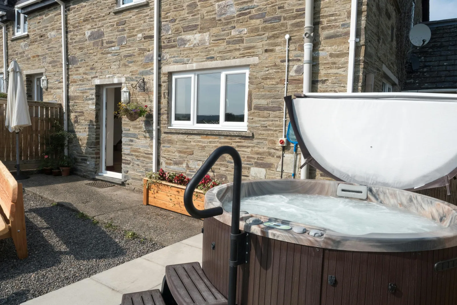 Outside of Elmtree Cottage with hot tub