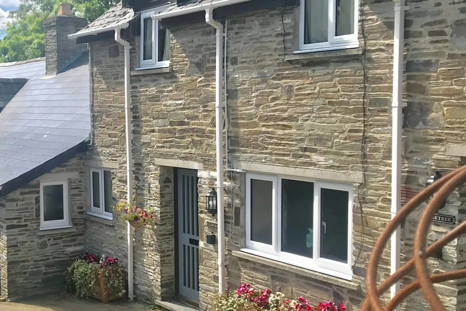 Front of Elmtree Cottage with containers of floweers