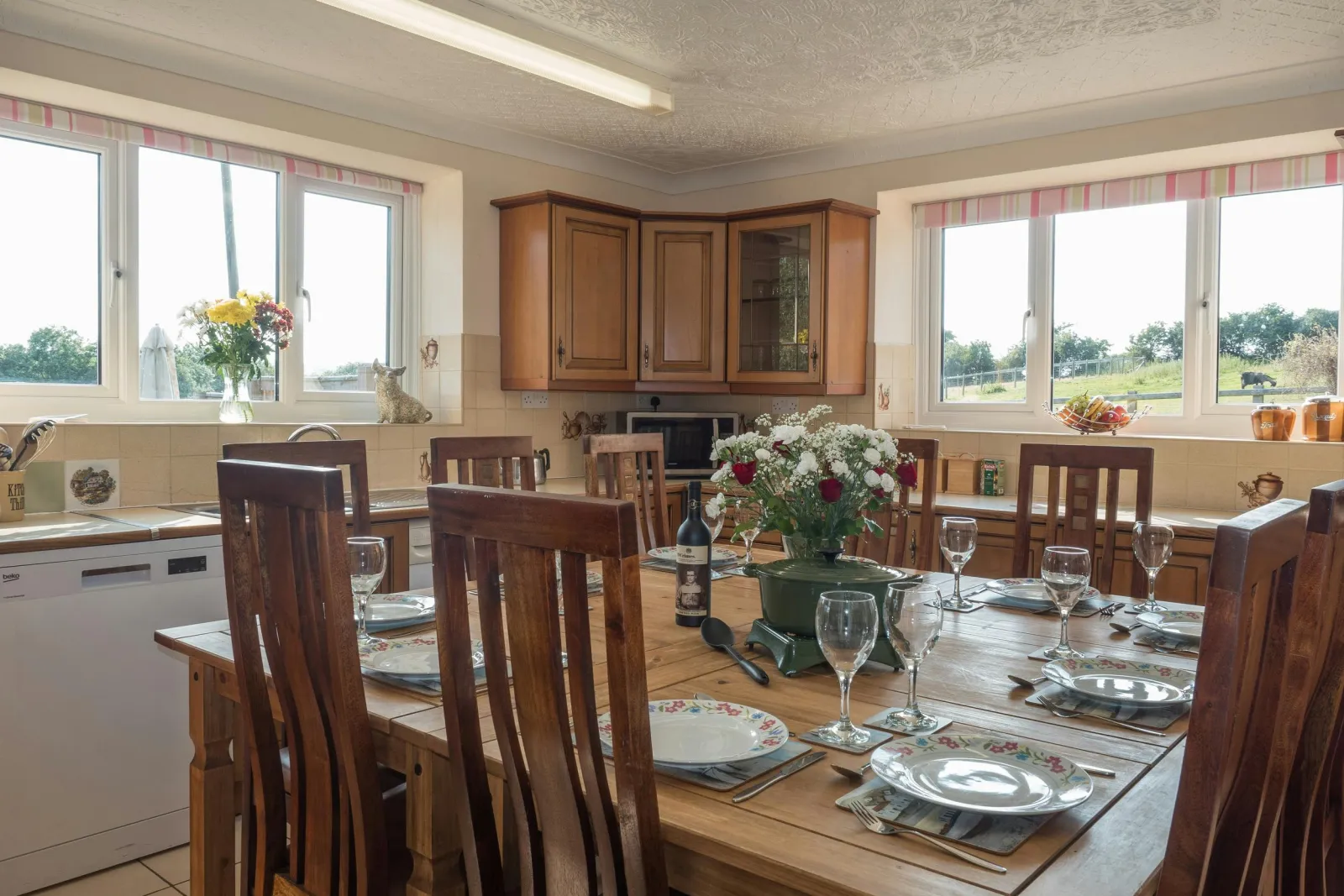 Fitted kitchen; microwave, dining table with ten chairs, windows overlooking the gardens