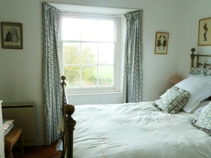 Double bed, bedside cabinet with lamp, chest of drawers and chair