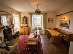Open fire, sofa, armchair, long bench, table with chairs, window seat