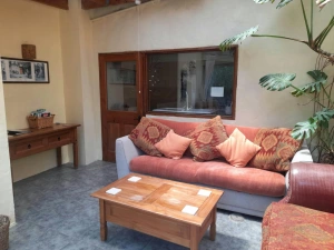 Sitting area at Uplands with sofa, coffee table and side unit