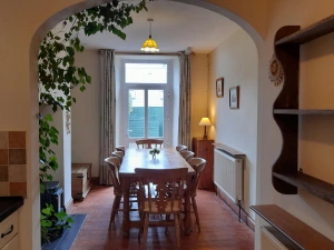 Wooden dining table seating nine. Door leading to the garden