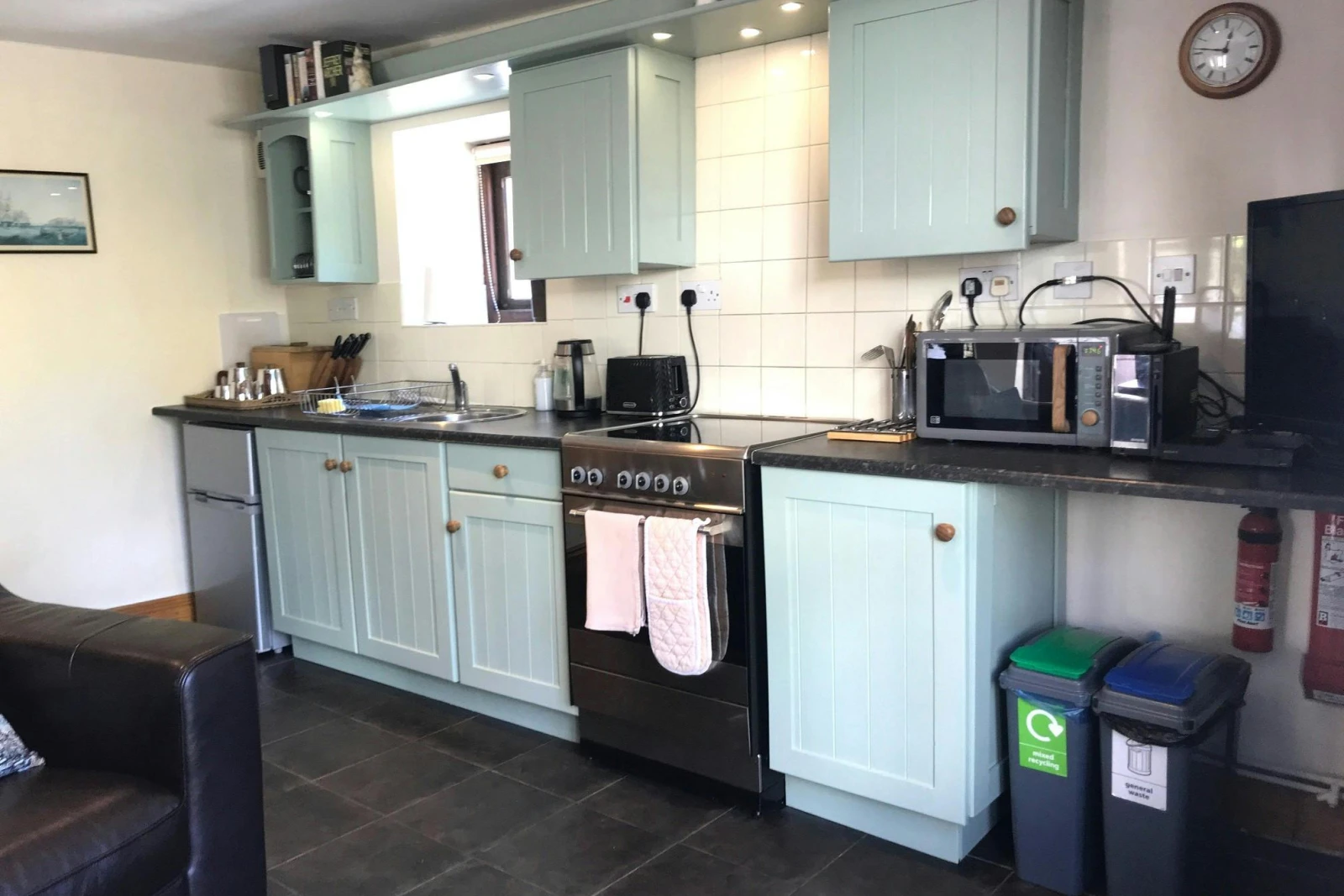 Kitchen with electric cooker, fridge, microwave, kettle and toaster