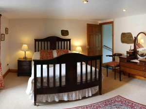 Double bedroom, bedside drawers with lamps, dressing table and chair
