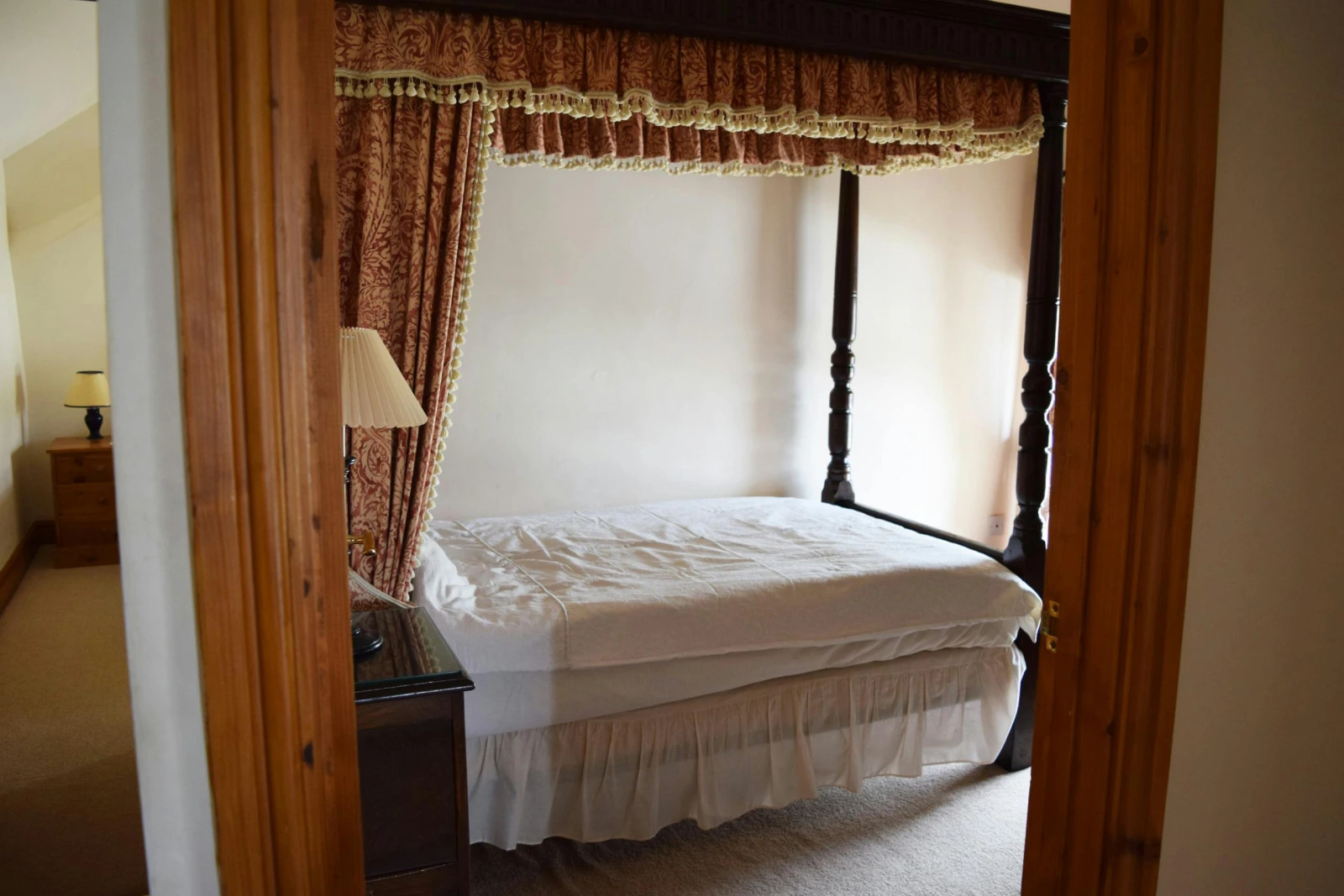 Four poster single bed, bedside cabinet with lamp