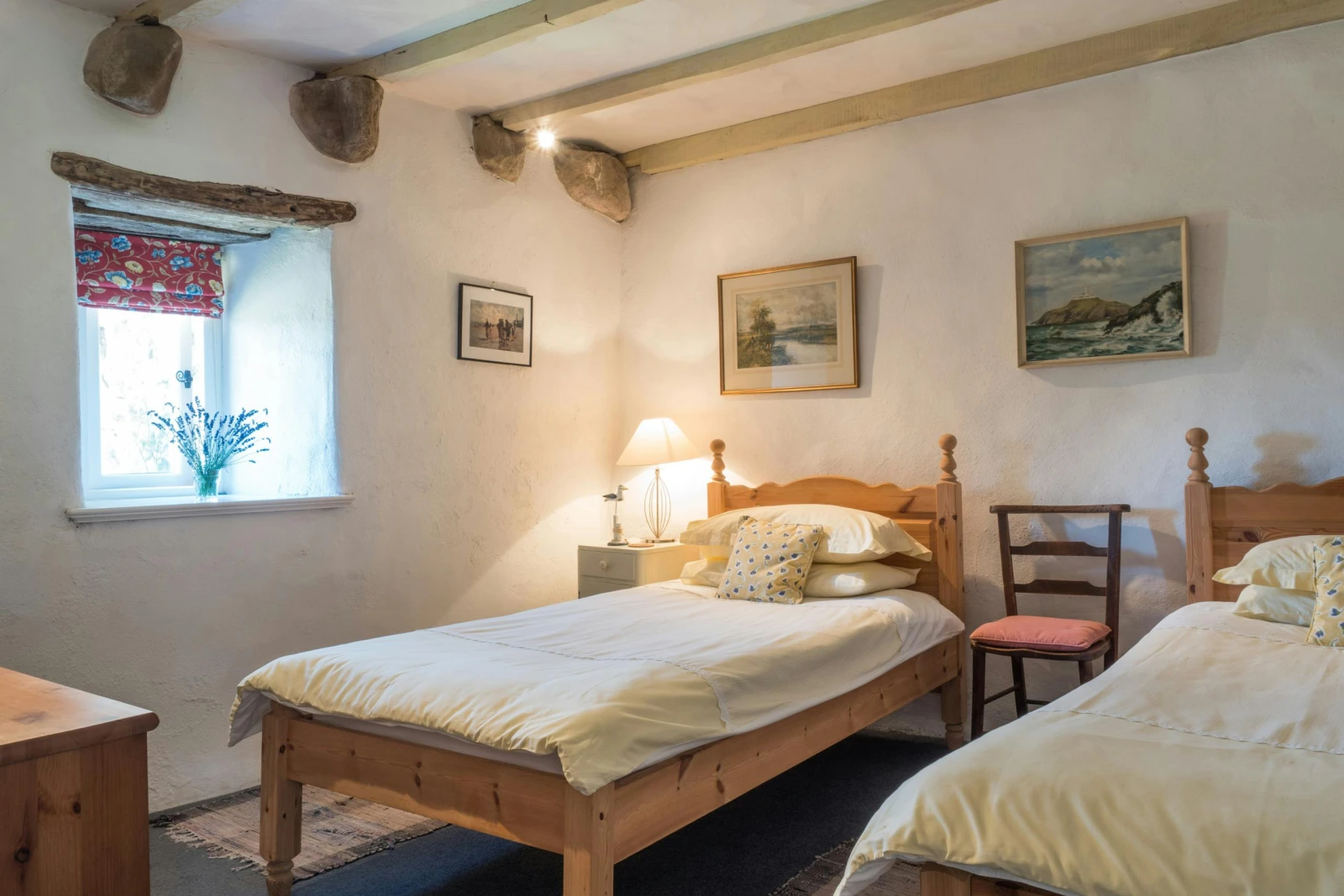 Twin single beds, bedside drawers with lamp and wooden chair