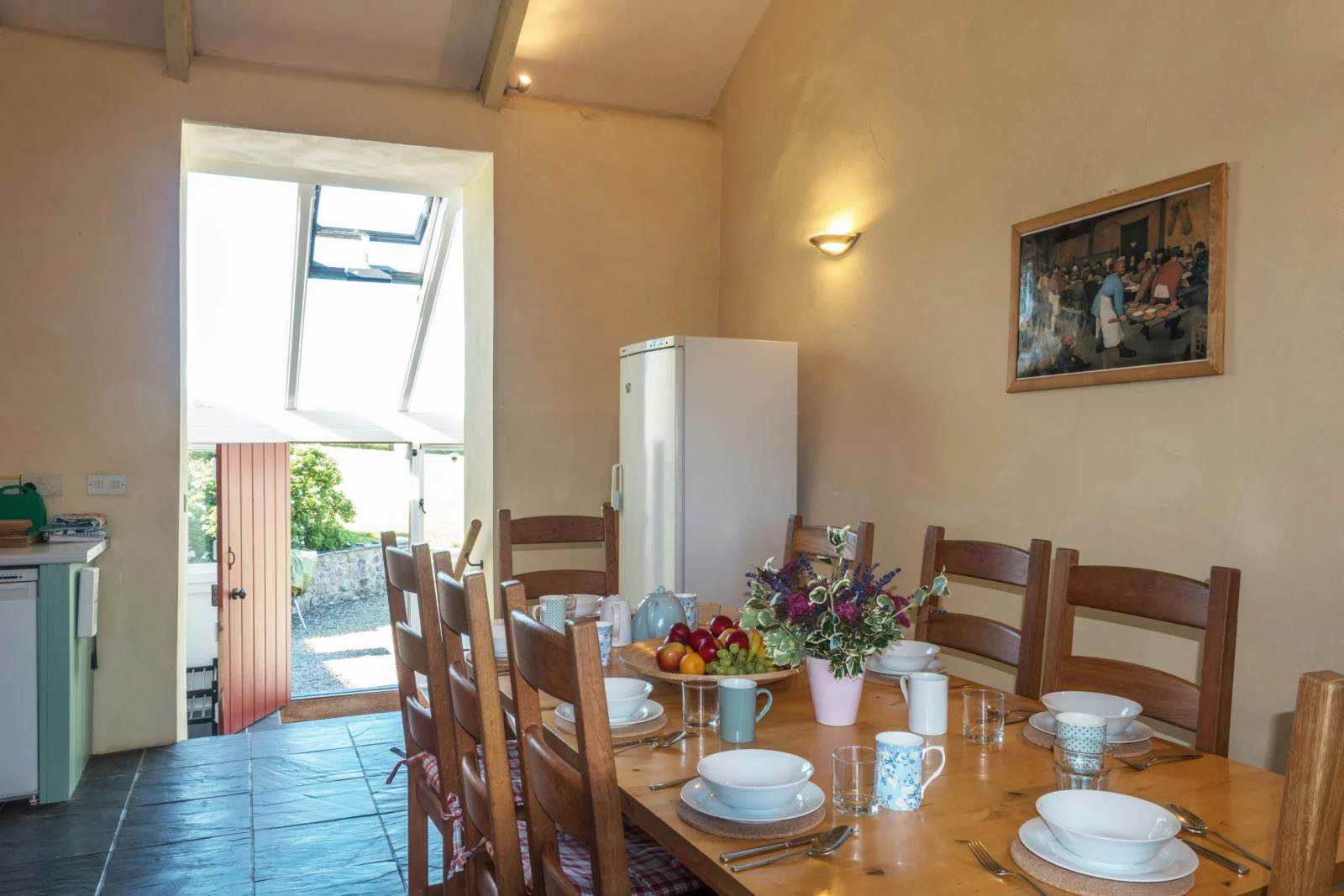 Dining area with table and chairs and fridge/freezer