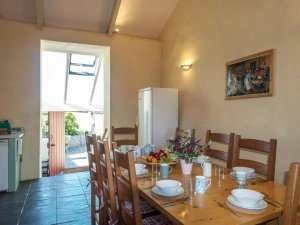 Dining area with table and chairs and fridge/freezer