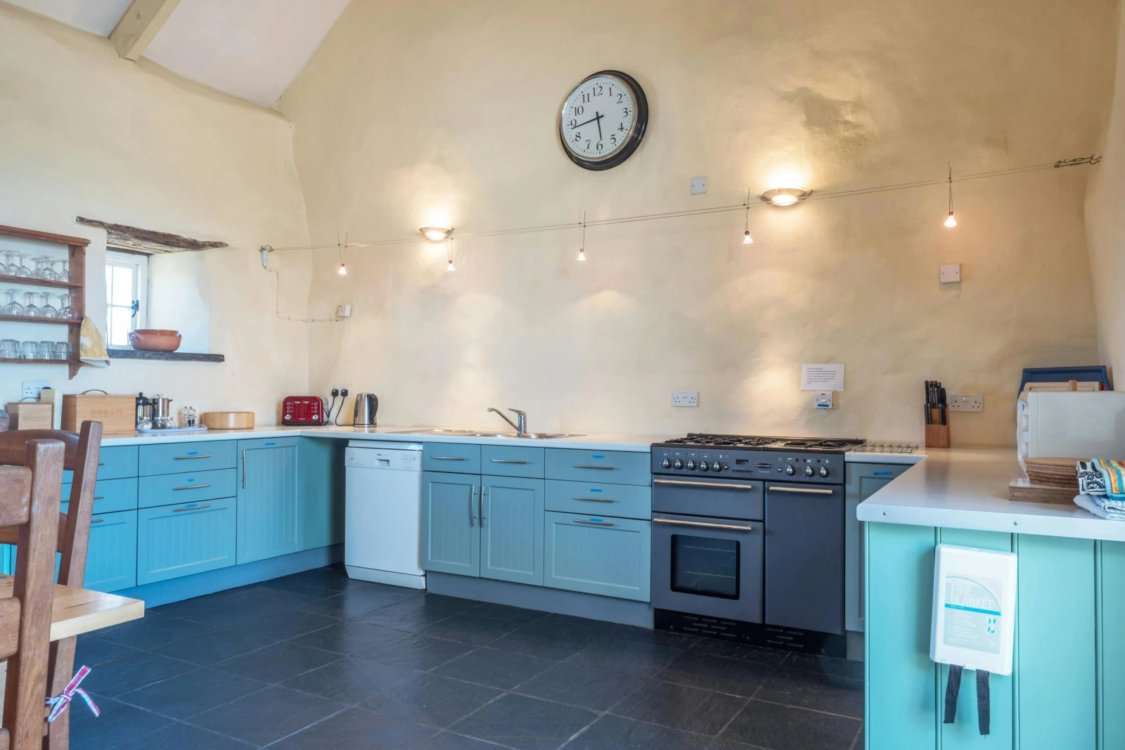Fitted kitchen with range cooker, dishwasher, microwave, kettle and toaster