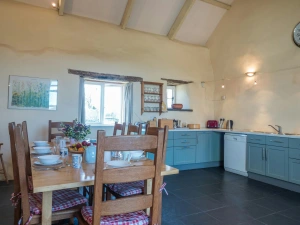 Fitted kitchen/dining area with table and eight chairs