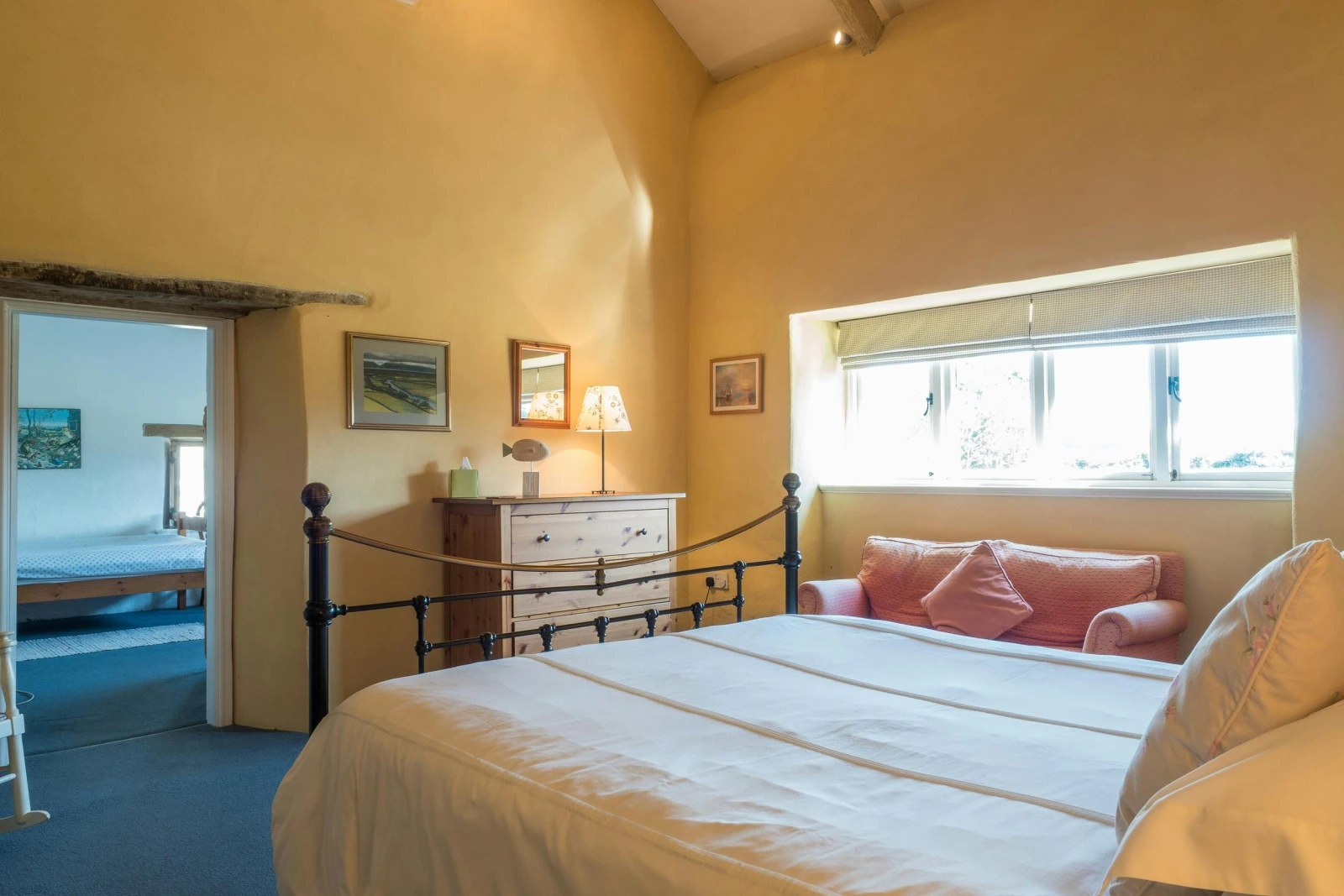 Bedroom, chest of drawers with lamp, sofa under the window