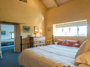 Bedroom, chest of drawers with lamp, sofa under the window