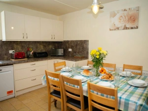 Fitted kitchen/dining area: dishwasher, microwave, toaster, dining table and eight chairs