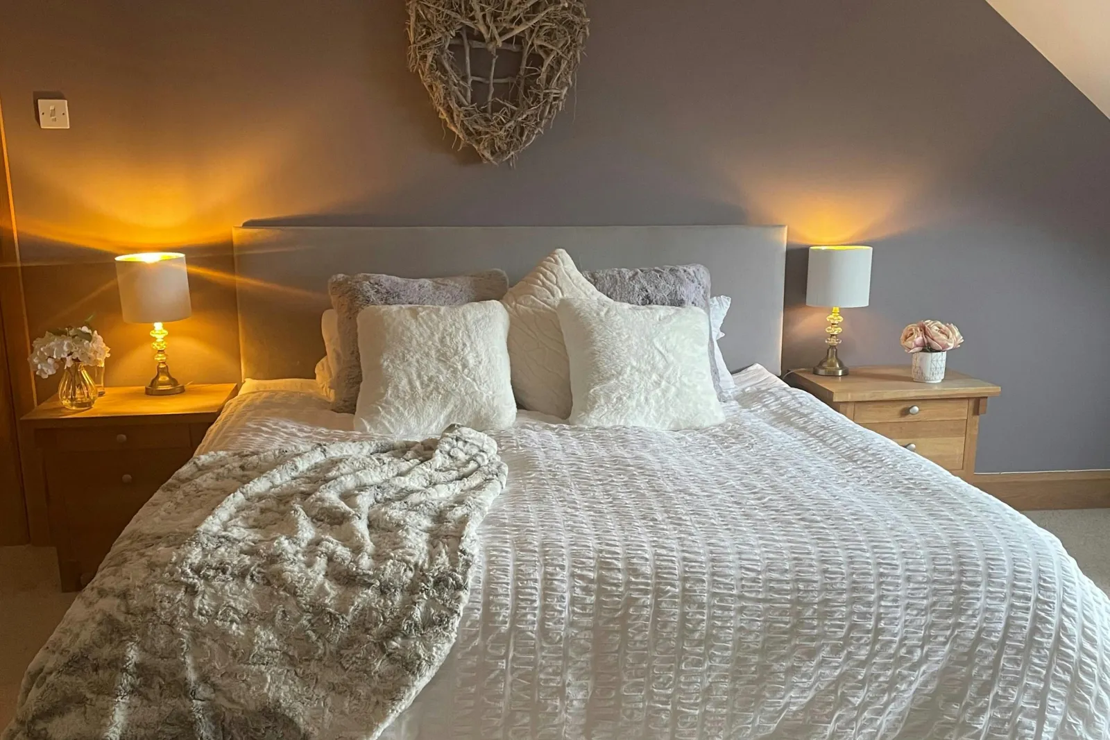 King size bed, cushions and throw, bedside tables with lamps
