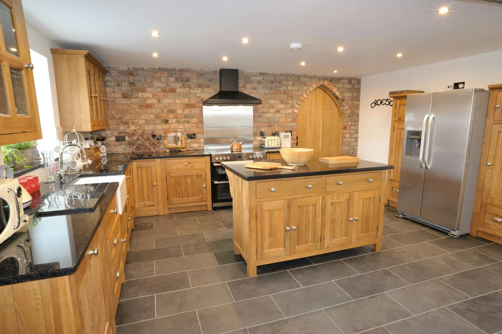 Large fitted kitchen with butlers sink, range cooker, fridge/freezer, microwave, kettle, toaster and central island