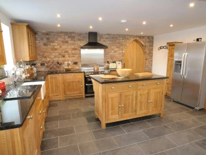 Large fitted kitchen with butlers sink, range cooker, fridge/freezer, microwave, kettle, toaster and central island