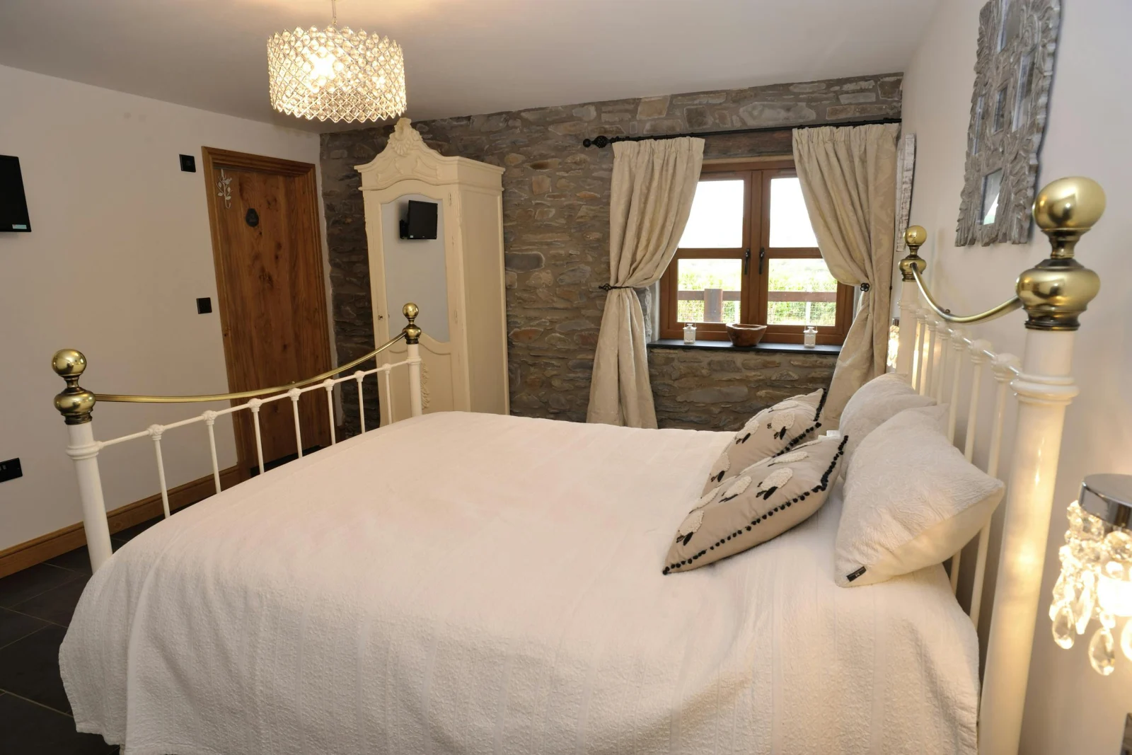 Downstairs king size bedroom, bedside cabinets with lamps and a small wardrobe