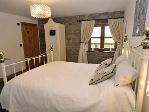 Downstairs king size bedroom, bedside cabinets with lamps and a small wardrobe