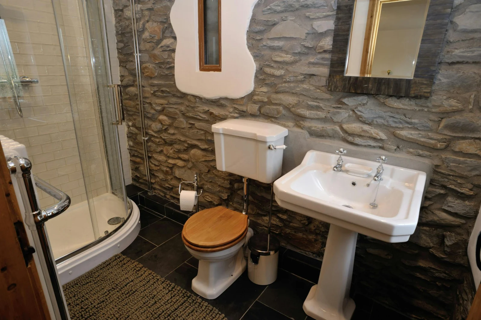 Downstairs en suite shower room: shower cubicle, wash basin with mirror above and WC