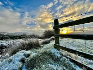 Countryside at sunset in winter, snow on the ground