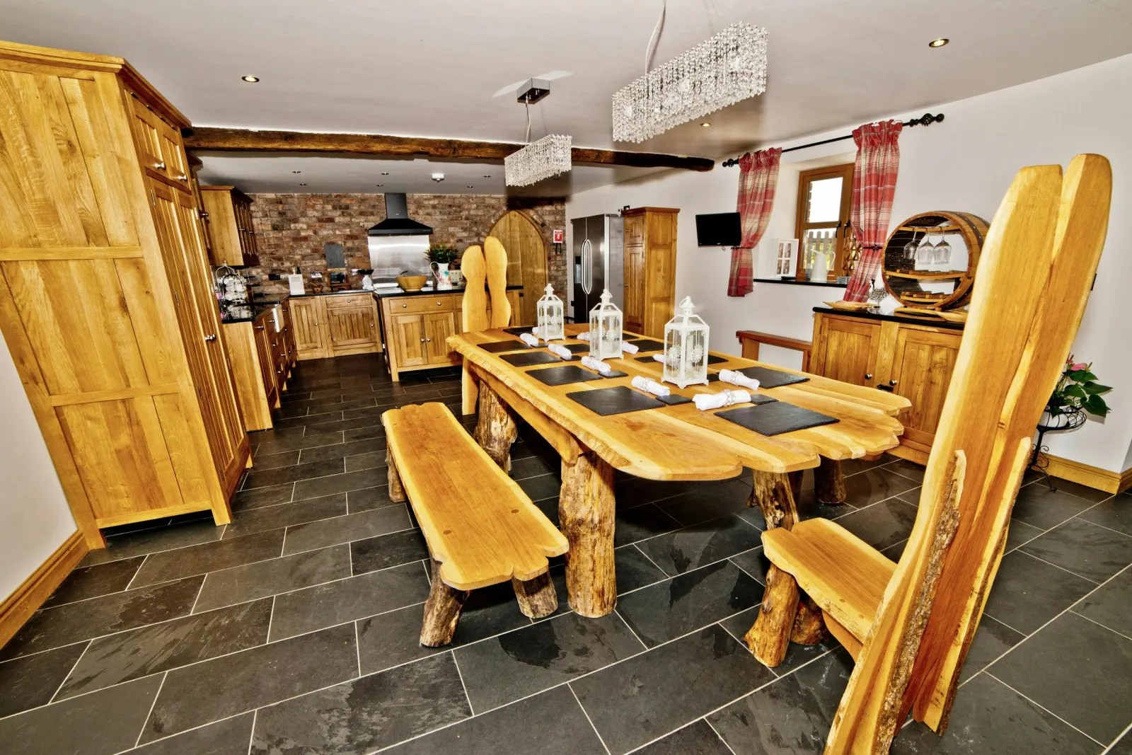 Dining area with large wooden table, benches and chairs