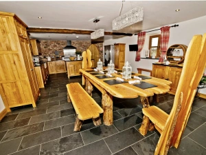 Dining area with large wooden table, benches and chairs