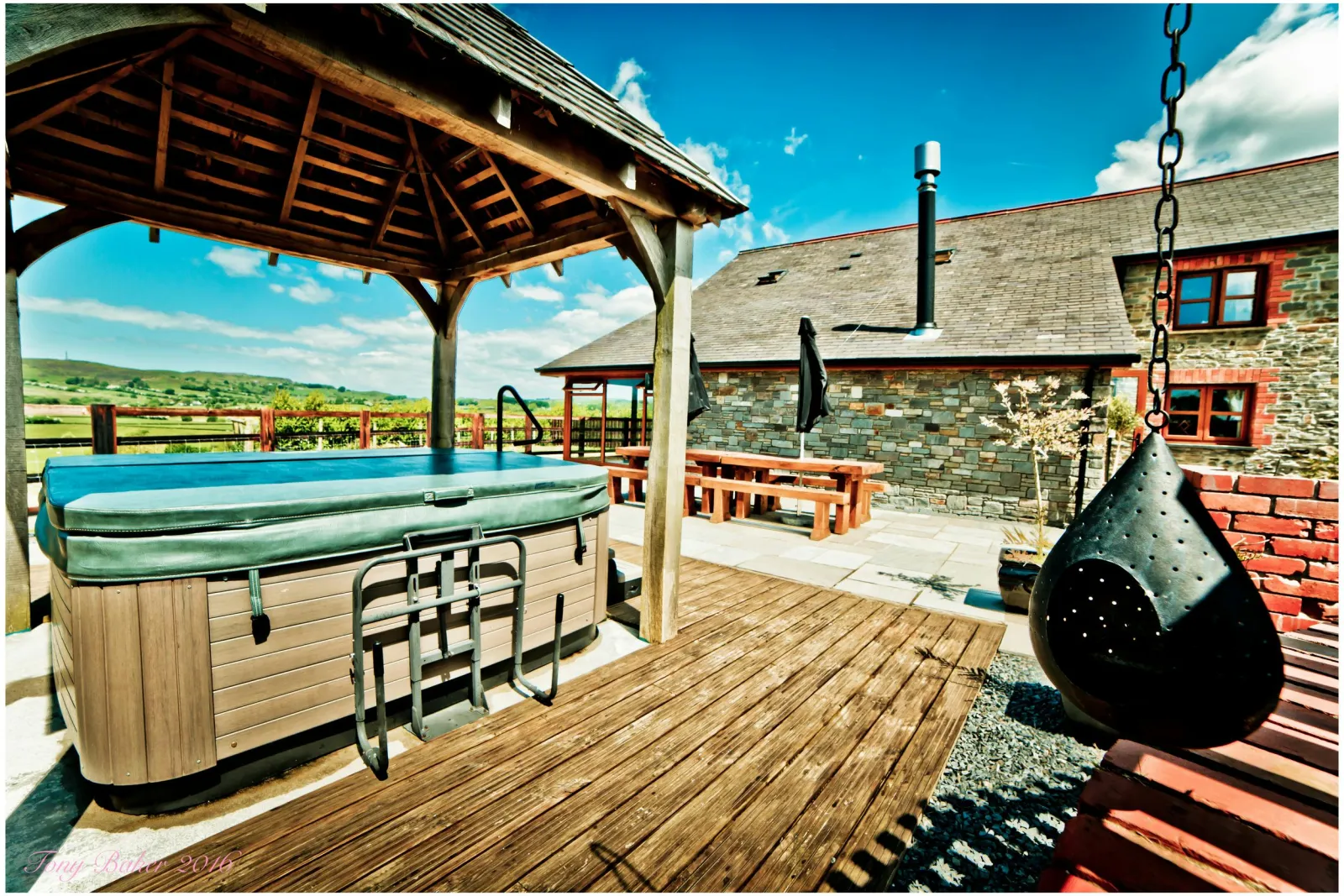 Hot tub with wooden canopy, deck area, swing