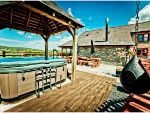 Hot tub with wooden canopy, deck area, swing