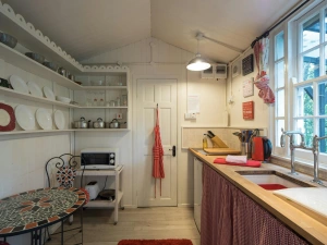 Kitchen/dining area: fridge, microwave, kettle and table with chairs