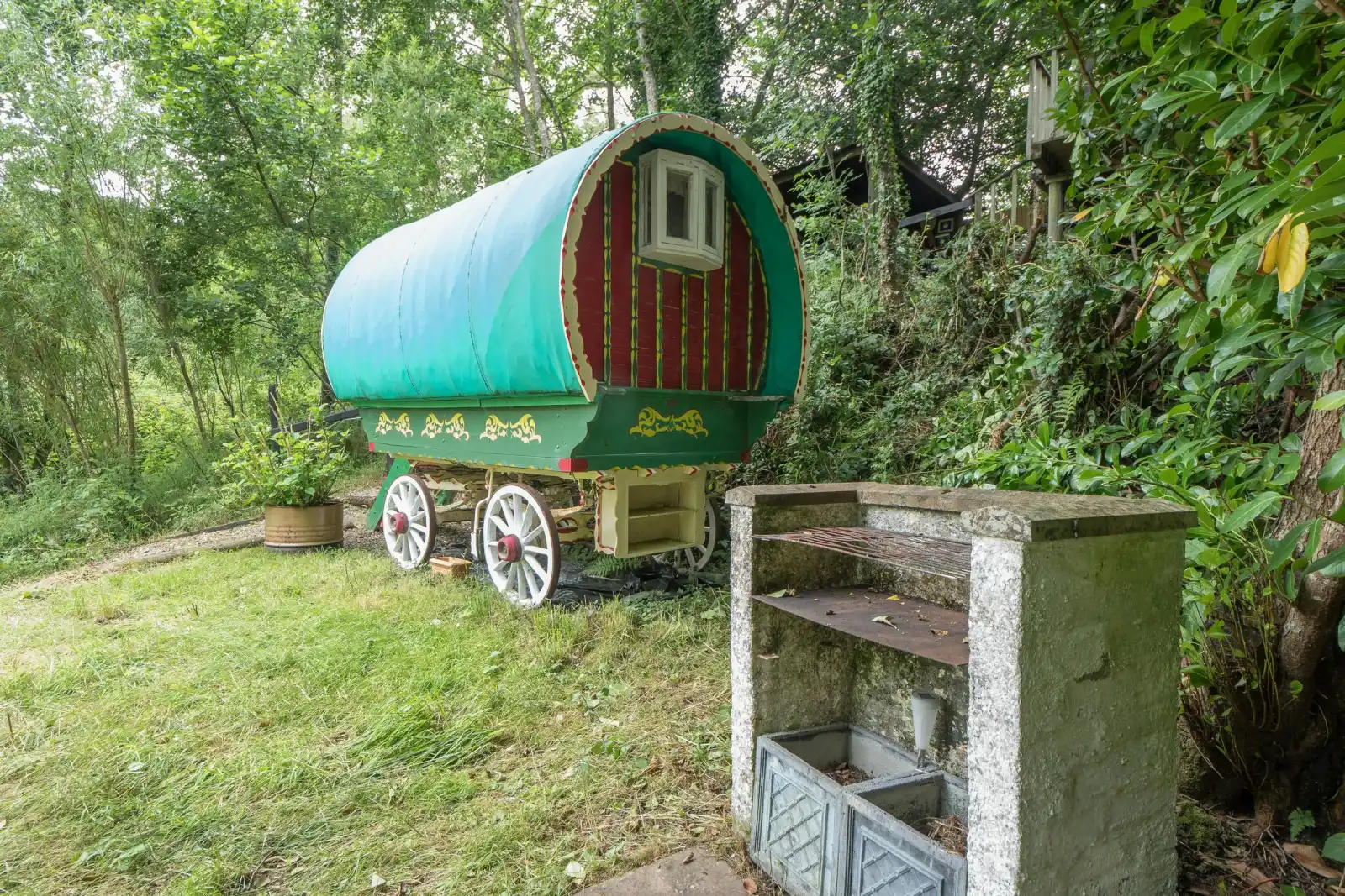 Romany wagon, surrounding trees and shrubs, barbeque