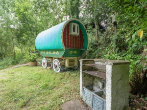 Romany wagon, surrounding trees and shrubs, barbeque