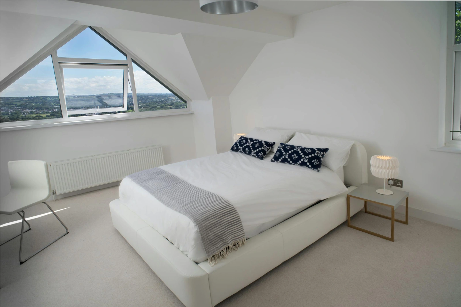 Double bed, chair and bedside tables with lamps