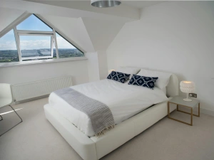 Double bed, chair and bedside tables with lamps