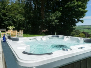 Hot tub in the garden with picnic table and chairs
