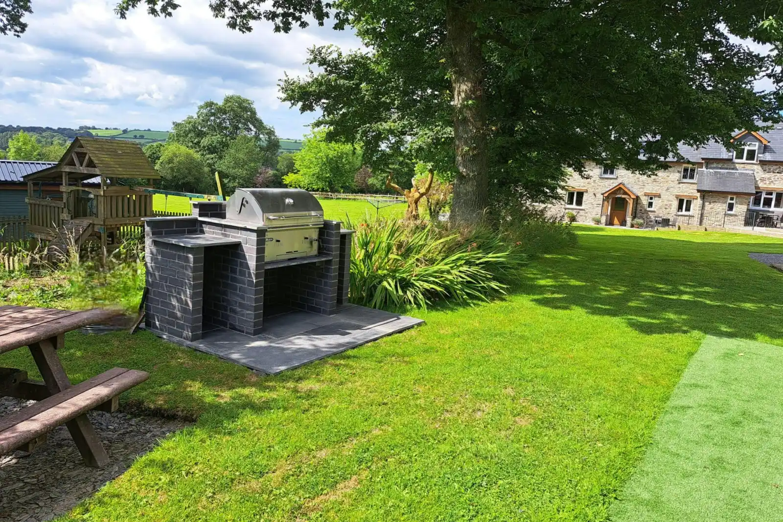 Communal charcoal BBQ and large lawn area