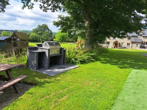 Communal charcoal BBQ and large lawn area