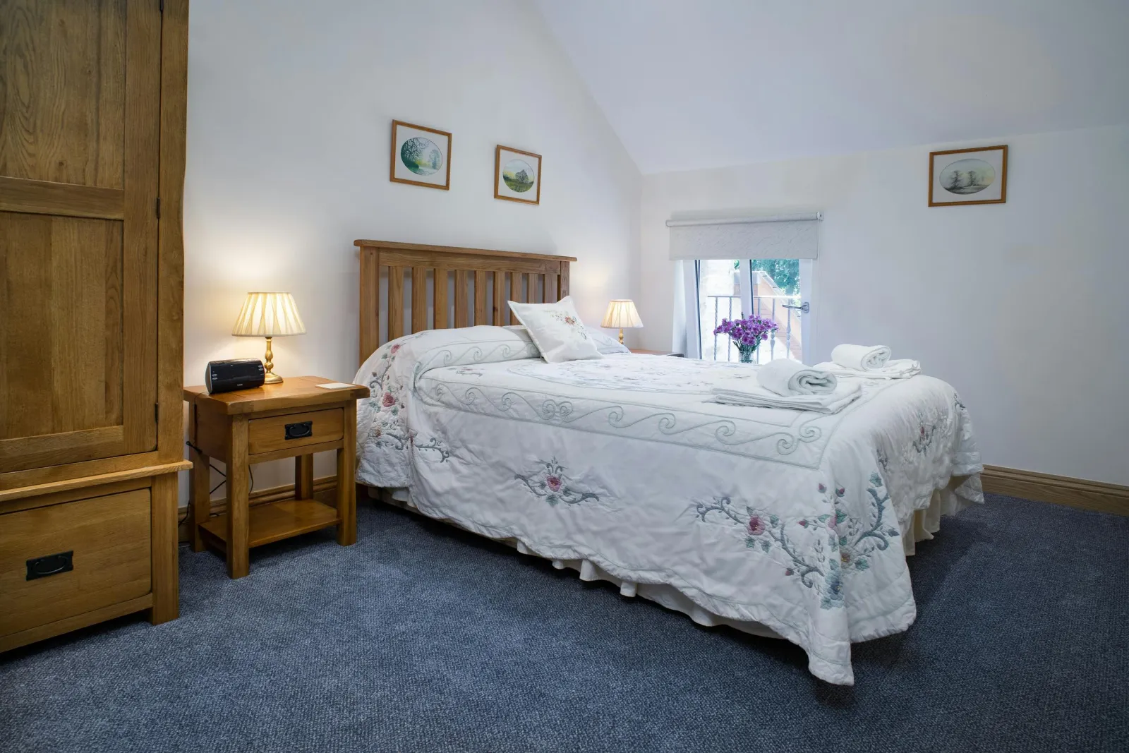 Double bed, bedside tables with lamps, wardrobe and window