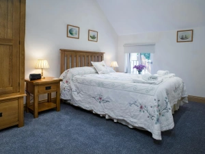 Double bed, bedside tables with lamps, wardrobe and window