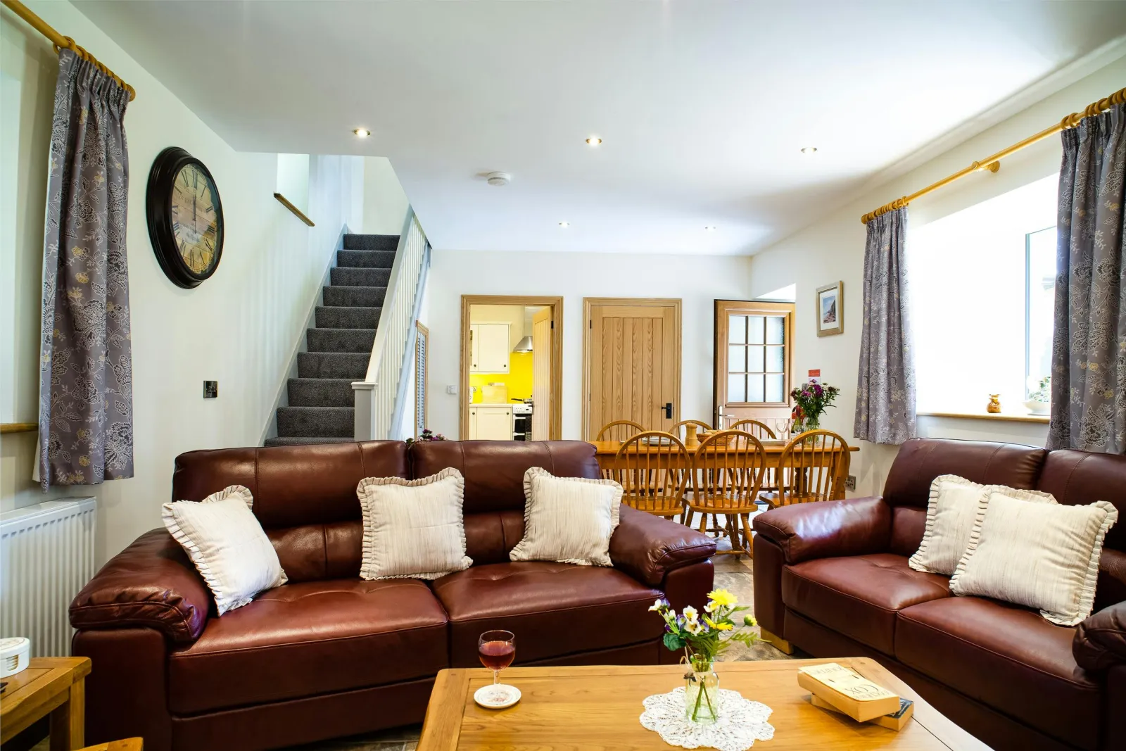 Sitting/dining room: leather sofas, coffee table, dining table and six chairs, stairs